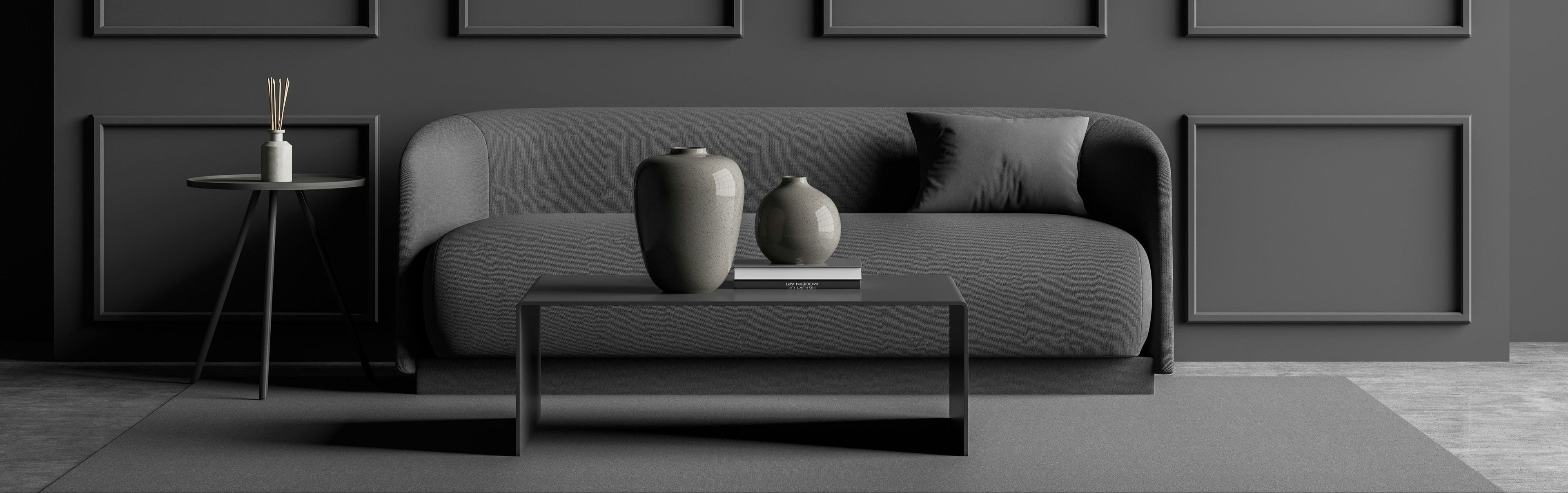 Modern living room with gray sofa, coffee table, and wall art